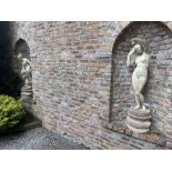 A pair of classical style composition Garden Figures, depicting female nudes, each on circular