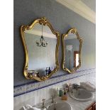 A pair of cartouche shaped gilt Mirrors, each in scroll moulded frame, 43'' x 21'' (109cms x 79cms).