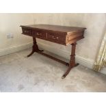 A Regency style three drawer mahogany Dressing Table, raised on reeded standards and four sabre