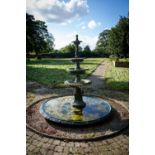 A green painted four tier cast metal Garden Fountain, each pan with a tongue and dart folded edge on