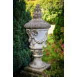 A massive pair of 19th Century composition stone Garden Urns and Covers, each cover with a flame