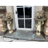 A pair of composition stone Garden Cherub Bird Baths, with shell bowls and double dolphin crests,