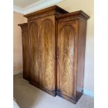 A fine Victorian breakfront Wardrobe, with raised centre and moulded cornice above four arched doors