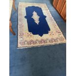 A good Persian Rug, with floral centre medallion on a dark blue ground inside a wide floral
