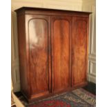 A fine quality Victorian mahogany Wardrobe, with three arched panel doors on a plinth base, 84"h x