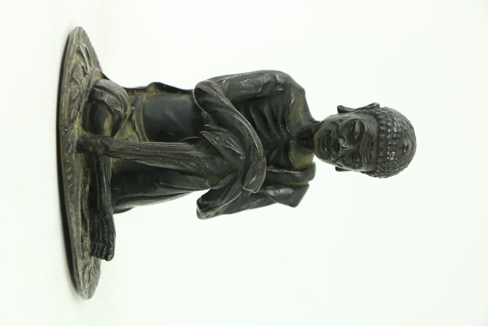 An early Chinese or Tibetanÿbronze Figure, of a seated Buddha with hands resting on left knee, 4 3/