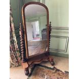 A Victorian mahogany Cheval Mirror, with arched plate on two spiral twist supports, on a