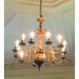 An antique Dutch wrought brass and brass 12 branch Ceiling Light, with multi knop stem and scroll