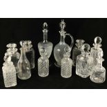 A large glass Claret Jug and stopper, 14" (36cms), a plain vase shaped glass Decanter and stopper,