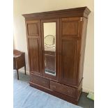 An early 20th Century walnut Wardrobe, with three doors and two drawers, 62" (157cms), together with