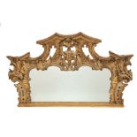 An attractive late 18th Century finely carved giltwood Overmantel Mirror, the shaped and pierced