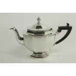 An octagonal crested silver Teapot, on stem base by Thomas Bradbury & Son, London 1912, with