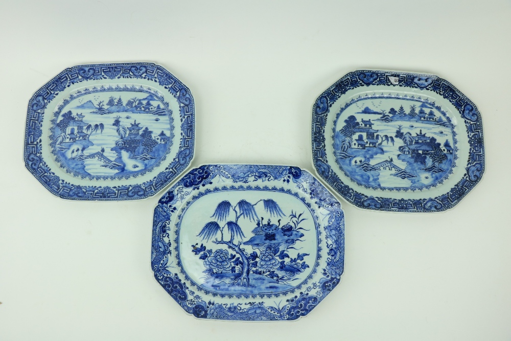 A pair of Nankin blue and white Meat Platters, decorated with figures and residents by a lake;