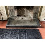 An early heavy cast iron Fire Curb, the top with canted sides, approx. 64" (163cms) wide. (1)