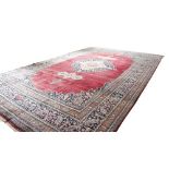 A fine semi-antique burgundy ground Persian Carpet, the large centre medallion with stylized