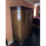 A Georgian style mahogany three door Wardrobe, with dentil moulded cornice on cabriole legs with