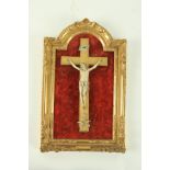 A fine early carved ivory Corpus Christi, mounted on a giltwood cross with ivory skull and cross