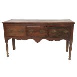 An 18th Century oak Dresser Base, with plank top above three frieze drawers on turned legs, 63" (