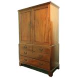 A George III period mahogany Gentleman's LinenÿCupboard on chest base, with moulded cornice above