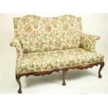 A late 18th Century double hump back walnut Settee, with padded back, arm panels and serpentine