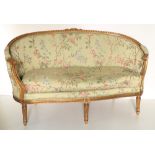 A 19th Century French style giltwood two seater Settee, with in-turned ends, on three front reeded