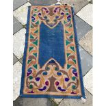 A Dun Emer Guild Irish woollen Celtic design Rug, the blue ground with ornate colourful border,