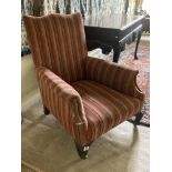 A Victorian walnut Armchair, with padded back, seat and arm rest, covered in attractive candy stripe