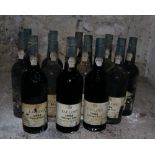 Twelve Bottles of Taylors 1985 Vintage Port, (imported by Woodforde Bourne), labels worn and damp