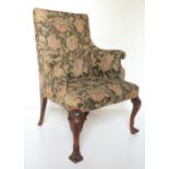 An 18th Century Irish mahogany Library Armchair, with padded back and arms covered in floral