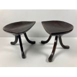 A pair of late 19th Century vernacular three legged Saddle Stools, with unusual splayed legs. (2)