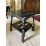 A small square ebonised two tier Aesthetic movement Occasional Table, on four turned legs, united by