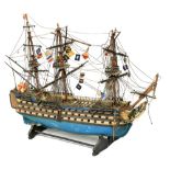 A painted wooden Model of HMS Victory, with three masts and various flags, 17" x 22" (53cms x