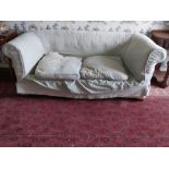 A late 19th Century Chesterfield Settee, covered in light blue loose fabric, with two loose