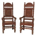 A pair of fine quality carved oak "Monks" Chairs, each with arched back carved in relief and