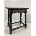 An early 18th Century oak Joiners Stool, the plain seat with sloped reeded edge,, and serrated ends,