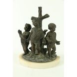 A Religious bronze Group, modelled with three cherubs in prayer by a tree stump in the form of a