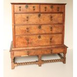 An early 18th Century figured walnut Chest on Stand, the crossbanded top with moulded edge, over two