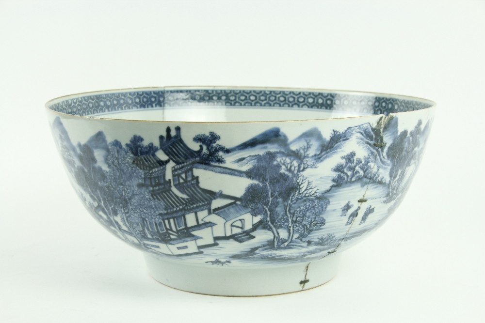 A large blue and white Chinese Qianlong period (1736 - 1795) Punch Bowl, decorated with landscape