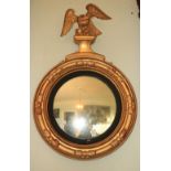 A fine quality early 19th Century circularÿconvex giltwood Mirror, with carved eagle surmounted, and