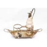 A George III silver boat shaped two compartment Cruet Stand, with one cutglass and silver mounted