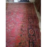 A large Turkish Ushak woollen Carpet, the red ground with overall stylized flowers and medallions