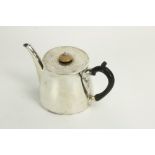 A Victorian silver crested Teapot, London 1859, by Robert Garrard, with ebonised handle,