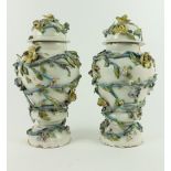 A pair of 18th Century ContinentalÿFaience flower encrusted Vases and Covers, each of baluster form,