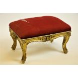 An Irish Georgian period gilt and gesso Stool, in the rococo style with rectangular padded seat on