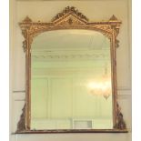 A Victorian gilt and gesso Overmantel, with arched and ribbon crest above a plate mirror with egg n'