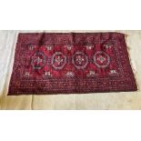 A red ground Bokhara Rug, with four octagons inside a multi band border, 76" x 42" (194cms x