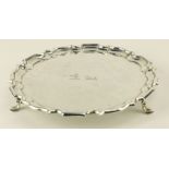 A small silver Salver, Sheffield 1951, with scalloped edge on three scroll pad feet, 8" (20cms)