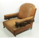 An Irish Victorian walnut Open Armchair, covered in tan hide on front baluster legs. (1)