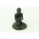 An early Chinese or Tibetanÿbronze Figure, of a seated Buddha with hands resting on left knee, 4 3/