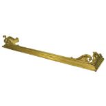 An unusual 19th Century brass Fender, the front corners cast with winged gargoyles on a reeded and